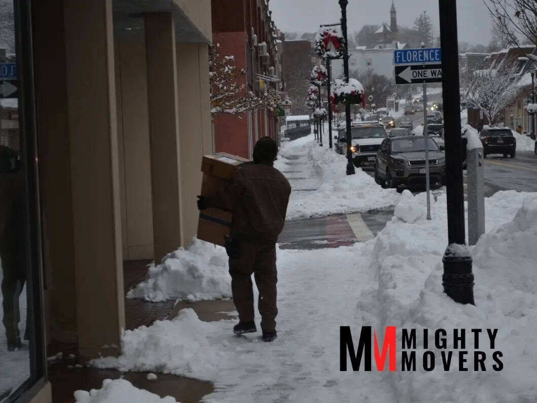 a man carrying box after a marlborough snow storm